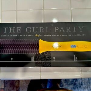 Heated curling brush by acclaimed Drybar brand.